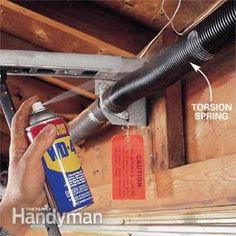 an image of a man fixing a duct in the ceiling with a spray bottle and tools