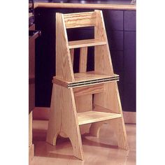 a wooden step stool sitting on top of a hard wood floor