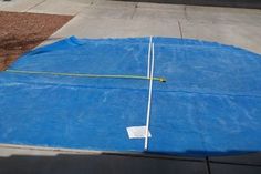 a large blue tarp on the side of a road