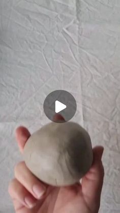 a person holding a rock in their hand with the caption's video below it