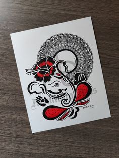 an elephant with red flowers on its head is shown in black and white, as well as the word'ganeshi '