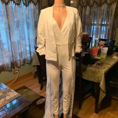 Ok Ladies, You Will Enjoy This White Polyester & Lace Jumpsuit... Can You Say, Destination Wedding!!! This Going Again Jumpsuit Is Sure To Get Attention! Whether If You're Getting Married On The Beach, Or In Las Vegas... This Jumpsuit Is To Die For! *With A Deep V-Neck *New With Tags *Sleeveless & Beautiful Lace Train Detail. *Excellent Stretch *Size Medium *Back Zipper *Back Lace Detail *Can Be Worn With Or Without Jacket (Jacket Not Included) Sleeveless Fitted Spring Pantsuit, Fitted Sleeveless Pantsuit For Spring, Fitted Sleeveless Spring Pantsuit, Sleeveless Spring Wedding Pantsuit, Spring Wedding Fitted Jumpsuits And Rompers, Sleeveless Sets For Date Night, Chic Sleeveless Wedding Pantsuit, Fitted Overall Pantsuit For Date Night, White Sleeveless Pantsuit For Night Out