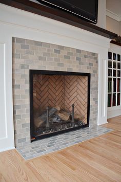 an empty living room with a fireplace in it