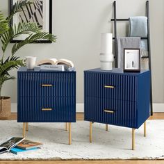 two blue nightstands sitting next to each other on top of a rug in a living room