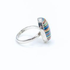 Sterling Silver Rainbow Calsilica Ring Size 9. This Sterling Silver ring features one large oval Rainbow Calsilica cabochon with beautiful colors. A man-made material that makes a great conversation piece. Ring is pre-owned and in great condition. Buy with confidence knowing that all precious metals are tested and are guaranteed with the Thermo Scientific Niton DXL Xray Scanner. All gemstones are authenticated using the Presidium Gem Tester II. Jewelry items come in a black velvet jewelry pouch Oval Multicolor Multi-stone Rings, Multicolor Multi-stone Opal Ring, Unique Multicolor Rings With Polished Finish, Multicolor Polished Ring Jewelry, Multicolor Polished Finish Ring Jewelry, Multicolor Polished Rings Perfect As Gift, Multicolor Polished Finish Rings For Gift, Multicolor Polished Rings As A Gift, Multicolor Polished Rings For Gifts