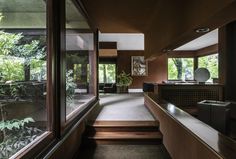 the inside of a house with lots of windows and wooden steps leading up to it