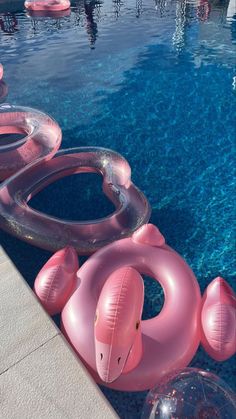 an inflatable pool float set next to a swimming pool with floats floating on it