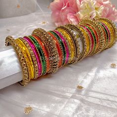 2 Large stacks of antique gold base and crystal detail luxury bangles with a mix of Pinks, oranges, yellows and green for that perfect mehndi night look! Ready to Ship with gift boxing. Gold Bangle With Zari Work For Party, Bollywood Style Bracelets With Zari Work For Parties, Bollywood Zari Work Bracelets For Party, Festive Multicolor Bracelets With Gota Work, Multicolor Gota Work Bangle For Festivals, Multicolor Gota Work Bracelets For Festivals, Green Zari Work Bangle Bracelet, Yellow Wedding Bracelets For Diwali, Gold Bollywood Bangle For Navratri