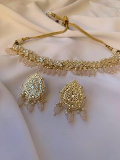 Introducing our exquisite Pear Shaped Gold Earrings + Choker Necklace Set, a mesmerizing blend of elegance and tradition. Each piece is adorned with vibrantly colored pearls, adding a pop of sophistication to your outfit. The intricate detailing of the Silver Kundan Jewelry Stones enhances the allure, reflecting the rich heritage of Indian, Pakistani, and Desi jewelry. Available in both dark blue and lavender colored pearls, this set offers versatility and grace, making it the perfect choice for any occasion. Elevate your style with this timeless masterpiece, crafted to perfection for the modern woman who cherishes tradition with a contemporary twist. Dark Blue And Lavender, Modern Wedding Jewelry, Desi Jewellery, Desi Jewelry, Colored Pearls, Neck Pieces Jewelry, Wedding Necklace Set, Jewelry Stones, Kundan Jewelry