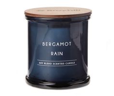 bergamoot rain scented candle in a glass jar with wooden lid on white background