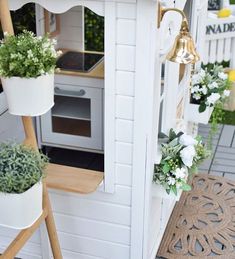 an outdoor kitchen with potted plants on the outside