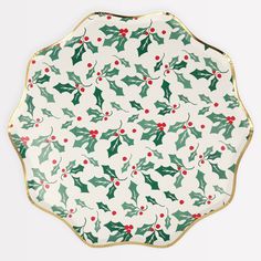 a holly and berry plate on a white background