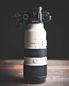 a camera mounted on top of a large lens