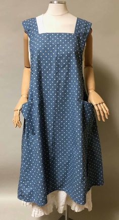 a mannequin wearing a blue dress with white polka dots