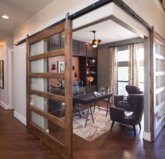 an open living room and dining area with sliding glass doors that lead into the kitchen