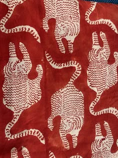 a red and white cloth with elephants on it