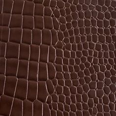 a close up view of a brown alligator skin pattern on a piece of leather material