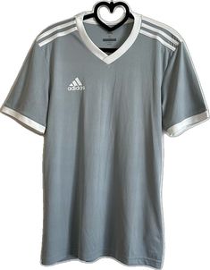 White Adidas Workout T-shirt, White Adidas Logo Sportswear Tops, White V-neck Sports Jersey, Adidas Logo White T-shirt For Workout, White Adidas Logo T-shirt For Workout, White Adidas Crew Neck Activewear, White Adidas Logo Crew Neck Activewear, White V-neck Top For Sports Season, Jersey Sports Top With Three Stripes