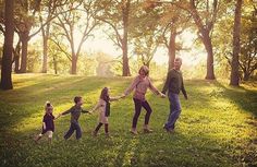 a group of people holding hands in the grass