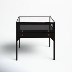 a black glass table with two drawers