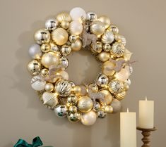 a christmas wreath with gold and silver ornaments