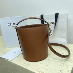 TEEN BUCKET mini 16 smooth cow leather bucket bag
6 X 7 X 6 inches (16 X 18 X 16 cm)
Smooth calfskin
Lining: Cow leather
Turnlock closure
1 main compartment
Detachable leather shoulder strap 19 inches (47 cm) long
Leather handles are 2 inches (5 cm) long High-end Leather Bucket Bag, High-end Everyday Leather Bucket Bag, Luxury Bucket Bag For Office, Calf Leather Bucket Bag With Smooth Grain, Classic Calf Leather Bucket Bag For Office, Classic Calf Leather Bucket Bag For Business, Classic Office Bucket Bag, Leather Bucket Bag With Smooth Grain, Calf Leather Bucket Bag With Dust Bag