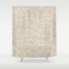 a beige shower curtain with floral designs on it