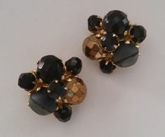 Perfectly Posh HATTIE CARNEGIE Signed Black And Golden Rhinestone Beaded Earrings Authentic Collectible Designer Vintage Luxury Jewelry... These highly collectible Très Chic Signed Hattie Carnegie earrings are comprised of Faceted Black and Coppery glass beads, Black Rhinestone rounds and Artful Two Tone Smoky Gray beads. Beautiful Black Mid Century Carnegie clusters to add to Your well curated Collection, a truly Sophisticated pair you'll love wearing often! These Beguiling Black Beauties measu Black Vintage Jewelry With Multicolored Beads, Black Multi-strand Costume Jewelry, Vintage Black Clip-on Earrings, Vintage Large Black Beads, Luxury Vintage Black Clip-on Earrings, Hattie Carnegie, Grey Beads, Perfectly Posh, Designer Vintage