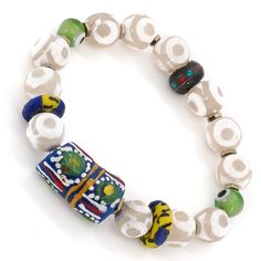 The Eye of Colors Bracelet is a beautiful piece of jewelry that is handcrafted using a variety of high-quality materials. The bracelet features White Nepal Agate stone beads, which are known for their calming and grounding properties. These beads are paired with Handmade paintings African beads, which add a pop of color and texture to the bracelet. The green evil eye beads are believed to provide protection against negative energy and promote good luck and prosperity. The Eye of Colors Bracelet Multicolor Large Beaded Bracelets For Meditation, Traditional Multicolor Natural Stone Beaded Bracelets, Traditional Multicolor Beaded Bracelets With Natural Stones, Traditional Agate Bracelets For Healing, Handmade Multicolor Agate Beaded Bracelets, Unique White Bracelets With Large Beads, Unique White Bracelet With Large Beads, Artisan Hand-strung White Bracelets, Artisan Hand-strung White Bracelet