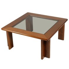 a square wooden table with glass top