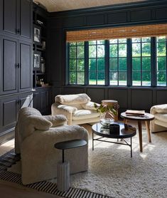 a living room filled with furniture and windows