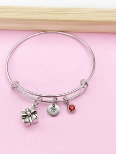 This is a silver-tone Present Gift Box and birthstone charm with hand stamped initial charm on Tarnish Resistant stainless steel bracelet. ♥ You will receive ONE bracelet. HOW TO ORDER 1) Choose the quantity. 2) Choose the initial and birthstone in the option or add a note to seller at checkout. 3) Add to the cart. DESCRIPTION ♥ Bracelet Bangle, Tarnish Resistant 304 Stainless Steel Expandable Bangle, Stainless Steel Color, Size: about 2-3/8 inch(6.05cm) inner diameter, 1.5~8.5mm wide. (Fit 6"-8.5" wrist), Nickel Safe ●The bangle is made from stainless steel, stainless steel is durable and highly resistant to water, rust, and corrosion. ♥ Initial Charms, Stainless steel, Size: about 8-10mm in diameter, 1mm thick, Nickel Safe. ♥ Present Gift Box, Tibetan Style Alloy Charms, Lead & Nickel & Gift Box Jewelry, Manufactured Stone, Red Tigers Eye, Jewelry Card, Box Jewelry, Birthstone Charms, Bracelet Bangle, Present Gift, Oils For Skin