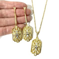 "A 1920s vintage style bridal jewelry set featuring Art Deco Gatsby wedding necklace and geometric dangle cz earrings on sterling silver posts, made of sparkly clear cubic zirconia with silver rhodium white or yellow or rose gold plated bail and chain. Earrings are about 2 1/4\" (5.7cm) with sterling silver posts. Pendant is 1 5/8\" (4.3cm) long with bail. Chain length can be added with a 2\" extender chain. Matching brooch pin at https://etsy.me/2Wk6HzE View matching pieces or similar designs a Art Deco Hallmarked Jewelry For Wedding, Art Deco Hallmarked Wedding Jewelry, Art Deco Sterling Silver Jewelry For Wedding, Sterling Silver Art Deco Jewelry For Wedding, Art Deco Jewelry With Diamond Accents For Evening, Art Deco Diamond Accented Jewelry For Wedding, Art Deco Diamond Cut Earrings For Wedding, Art Deco Wedding Jewelry With Diamond Accents, Art Deco Diamond Cut Wedding Earrings