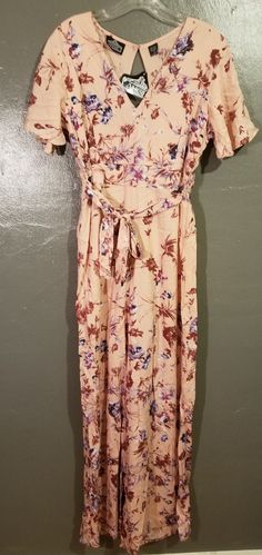 Peach Floral Balck Cut Out Jumpsuit With Wide Legs. Back Has Smocked Detail And Tie In Front. Brand New With Tags. Summer Beige Jumpsuits And Rompers With Elastic Waistband, Bohemian Jumpsuits And Rompers With Smocked Back For Spring, Bohemian Spring Jumpsuits And Rompers With Elastic Waistband, Bohemian Jumpsuits And Rompers With Elastic Waistband For Spring, Casual Flowy Jumpsuits And Rompers With Floral Print, Casual Flowy Floral Print Jumpsuits And Rompers, Bohemian Jumpsuits And Rompers With Smocked Bodice For Vacation, Beige Jumpsuits And Rompers With Elastic Waistband For Spring, Casual Jumpsuits And Rompers With Smocked Back For Daywear