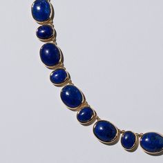 146.84 ct. combined weight of oval blue lapis lazuli cabochons Lapides measure up to 11.8mm long and up to 9.8mm wide Forty-four total stones secured in full bezel settings Necklace fastened with handmade box clasp closure Collar necklace style set by hand in 18k solid yellow gold Item Details Fine jewelry should be worn and stored with special attention, particularly when set with certain gemstones. Get the guide to Mociun collection upkeep on our website. Edwardian Engagement Ring, Lapis Lazuli Jewelry, Blue Lapis Lazuli, Colorless Diamond, Handmade Box, Gold Alloys, Box Clasp, Colored Gems, Blue Lapis