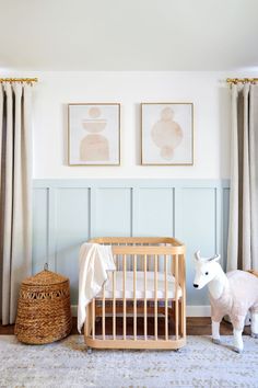 Nursery design Gender Neutral Nestig Mini Crib, Nursery With Mini Crib, Blue And Wood Nursery, Blue And Natural Wood Nursery, Blue Panelling Nursery, Nursery With Paneling, Light Blue Panelling, Light Blue Board And Batten Wall, Light Blue Board And Batten