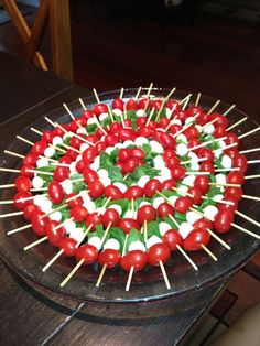 a platter with skewered tomatoes and mozzarella