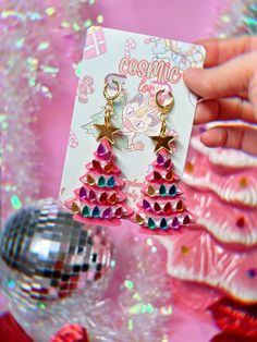 This listing is for ONE Pair of  Ceramic Christmas Tree Earrings. Available in Pink, Blue, White and Green!  If you wish to replace hardware to hooks, Hoops or clip on please leave me a note at checkout. Earring post backs are hypoallergenic. Earrings are approximately 3in in length.  *Follow me on IG for shop updates! @shopcosmiclovely Pink Earrings For Christmas Party, Pink Earrings For Christmas Gift, Pastel Christmas Clay Earrings, Boho Christmas Tree Earrings, Multicolor Christmas Earrings, Christmas Tree Pink, Rivers Edge, Christmas Cruise, Vintage Ceramic Christmas Tree