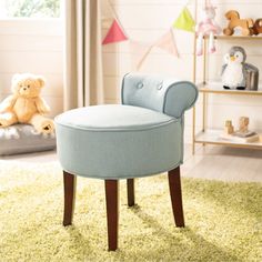 a child's bedroom with a blue chair and teddy bear on the floor in front of it