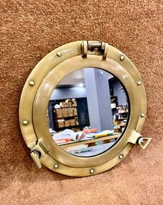 there is a mirror on the wall that has been made to look like a ship's porthole