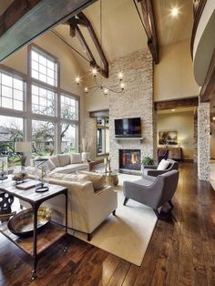 a living room filled with furniture and a fire place in the middle of it's walls