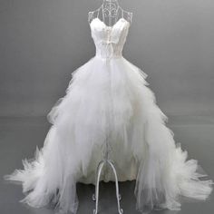 a white wedding dress is on display in front of a gray background with the words, d