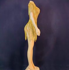 a mannequin wearing a yellow flap dress