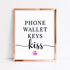 a pink lipstick print with the words phone wallet keys kiss in black and gold frame