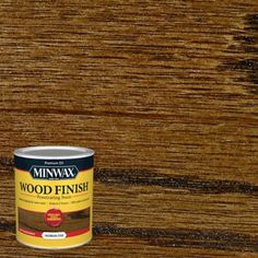 a can of wood finish sitting on top of a wooden floor