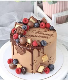 a chocolate cake with berries, raspberries, and other toppings on top