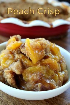 a close up of a bowl of food on a table with the words peach crisp above it