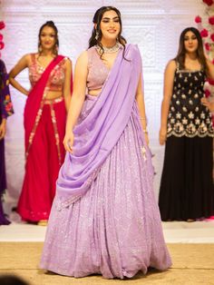 Embrace elegance and grace with the Samantha Lehenga. Crafted with intricate mirror, pearl, and stone embroidery work, this whimsical lehenga exudes a sense of grandeur, making it perfect for special events and occasions. Key Features: Precious mirror, pearl, and stone embroidery work Lavender color exuding beauty and grace Soft net fabric for a gorgeous and elegant look Elevate your style with the Samantha Lehenga, designed to bring out your innate grace and elegance. The silk blouse adorned wi Samantha Lehenga, Elegant Pre-draped Kundan Saree For Party, Elegant Pre-draped Saree With Kundan For Party, Elegant Kundan Pre-draped Saree For Party, Party Gown With Kundan Mirror Work, Party Pre-draped Saree With Sheer Dupatta And Kundan, Bollywood Style Floor-length Pre-draped Saree With Intricate Embroidery, Party Pre-draped Kundan Saree With Sheer Dupatta, Elegant Choli With Mirror Work For Reception