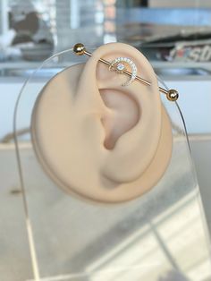 a pair of earring sitting on top of a glass table