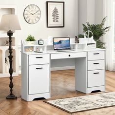 a white desk with drawers and a laptop on it